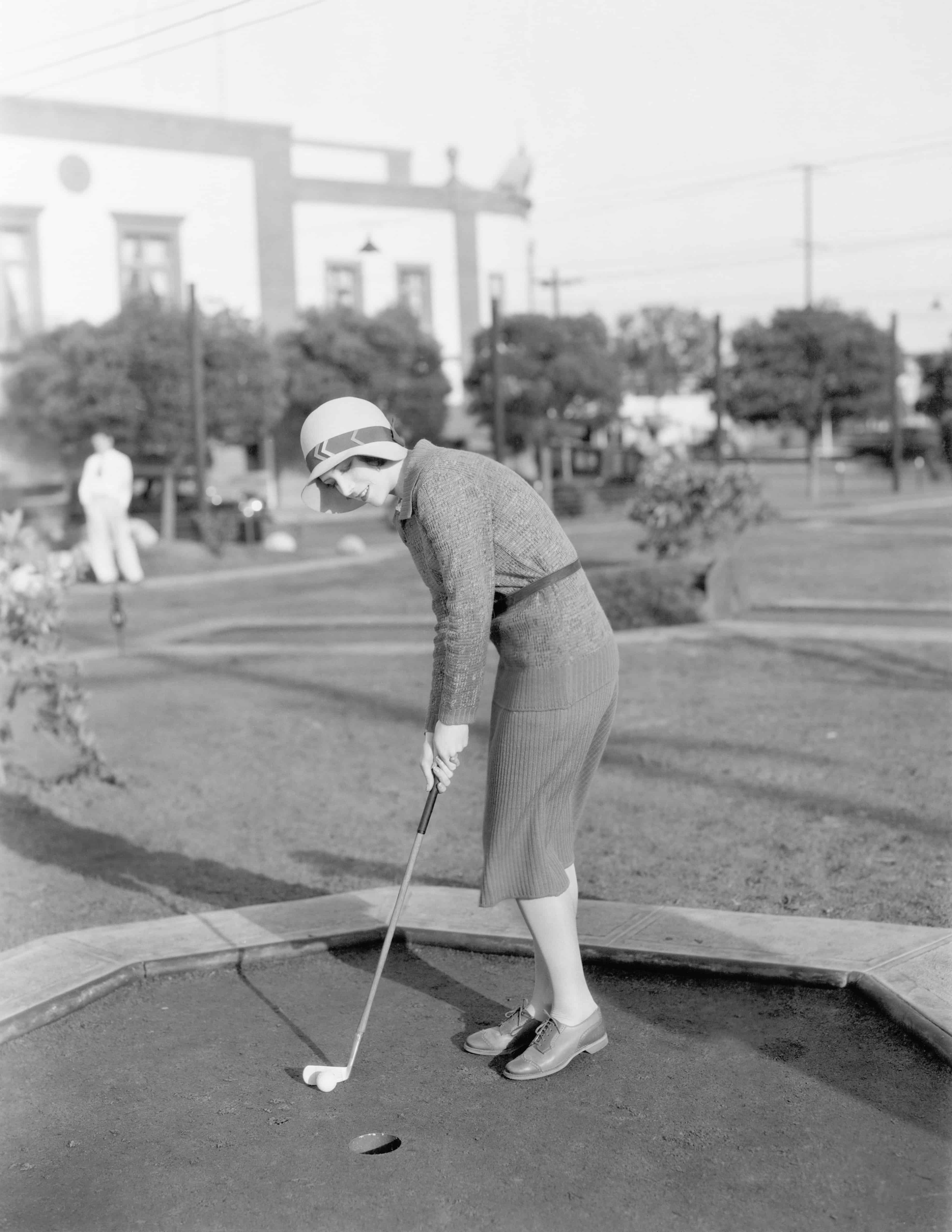 1920s female wearing a cloche and playing golf