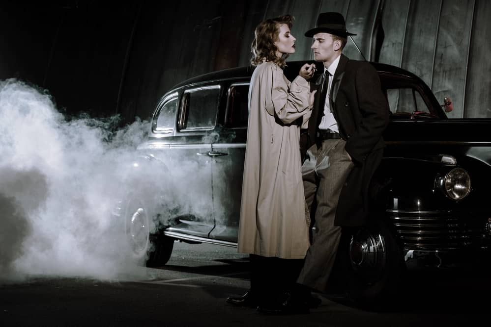 1920s couple standing by a car