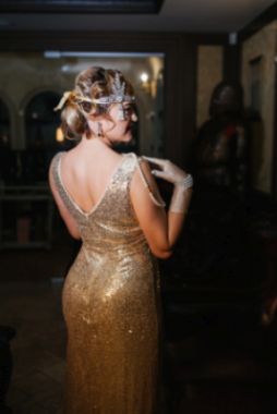 Back of a woman in a typical Great Gatsby Dress