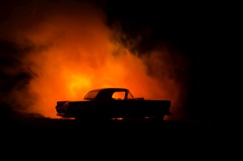 silhouette of a car on a flaming background