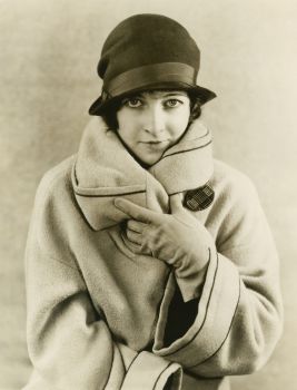 a woman wearing a heavy coat and a cloche